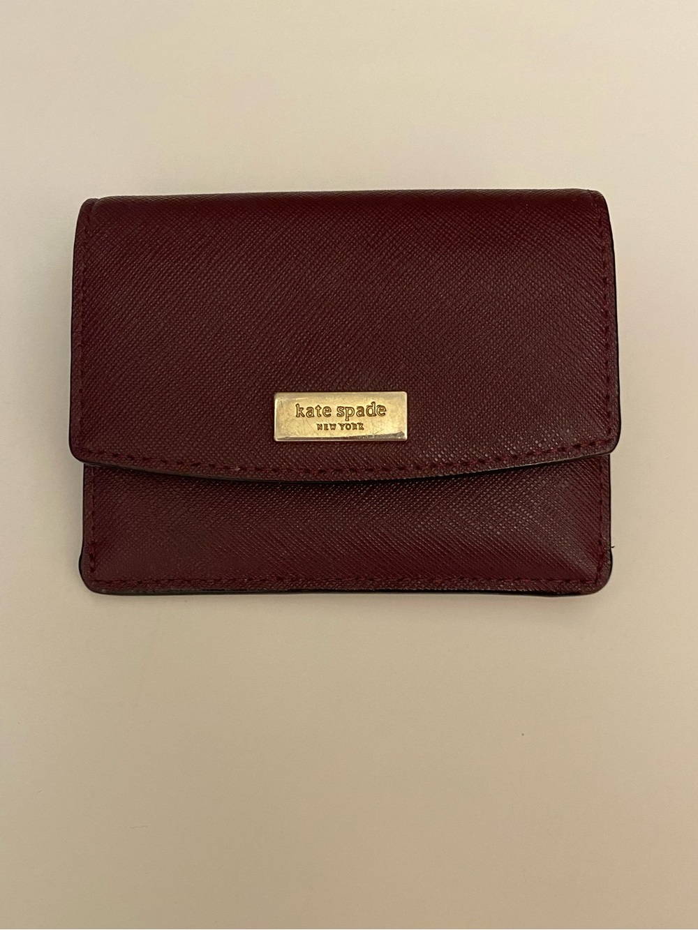 kate spade burgundy bi-fold wallet with gold plaque